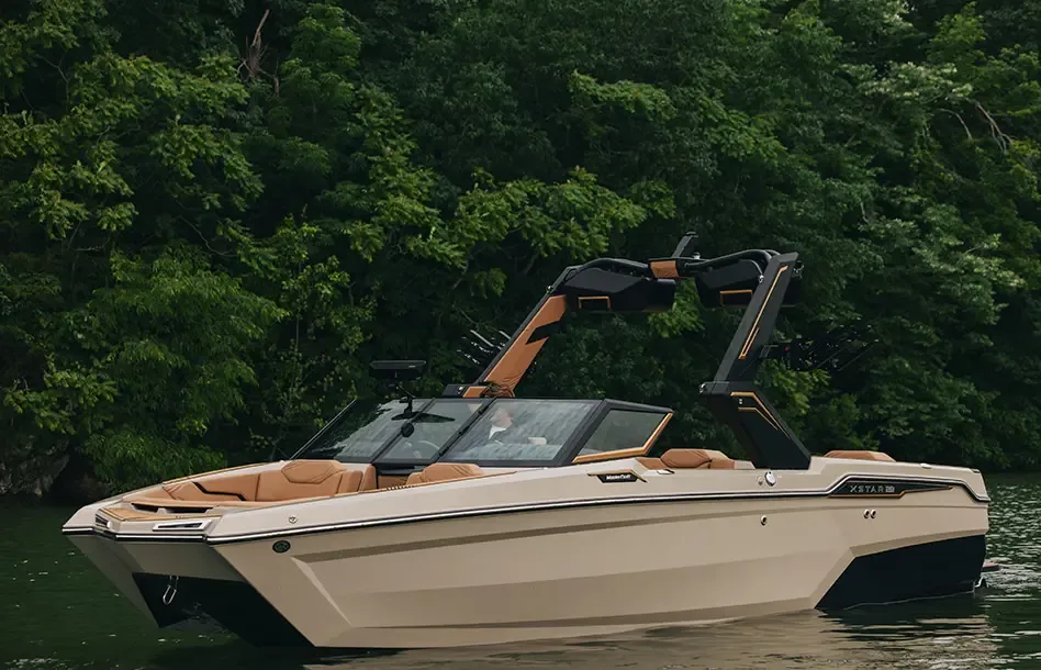 2026 MasterCraft XStar 23 wakesurf boat on a wooded lake