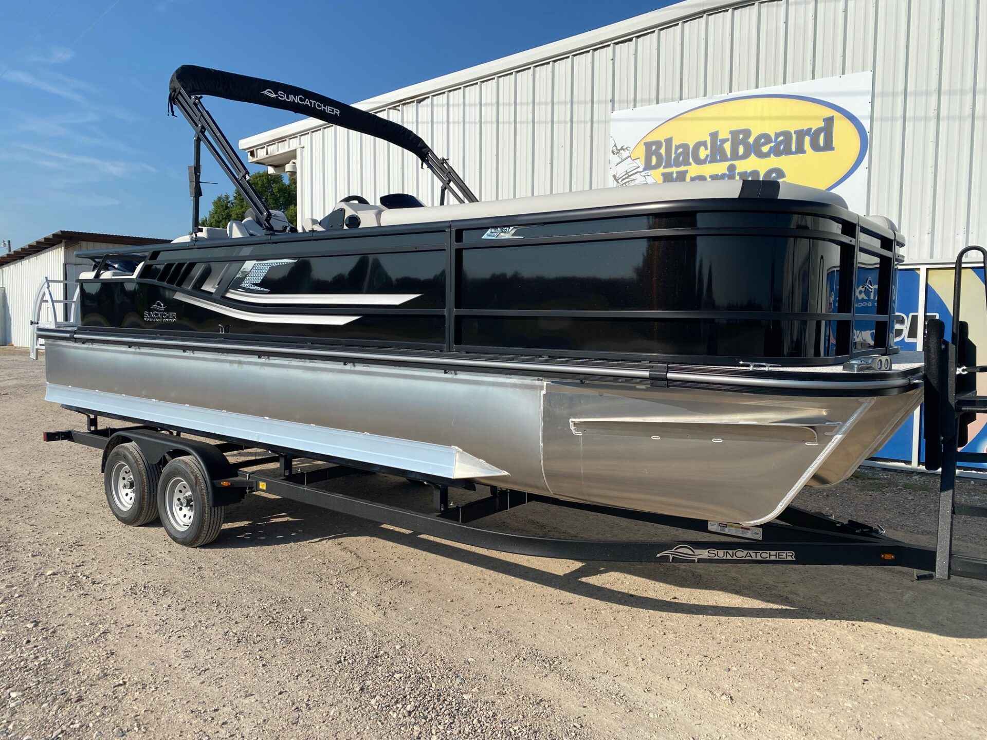 Black 2027 SunCatcher Select 324SS pontoon with bimini top on the lot at Blackbeard Marine in Kingston, OK