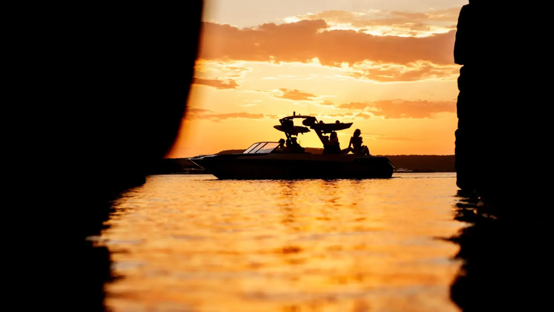Surf boat silhouetted against a lake sunset